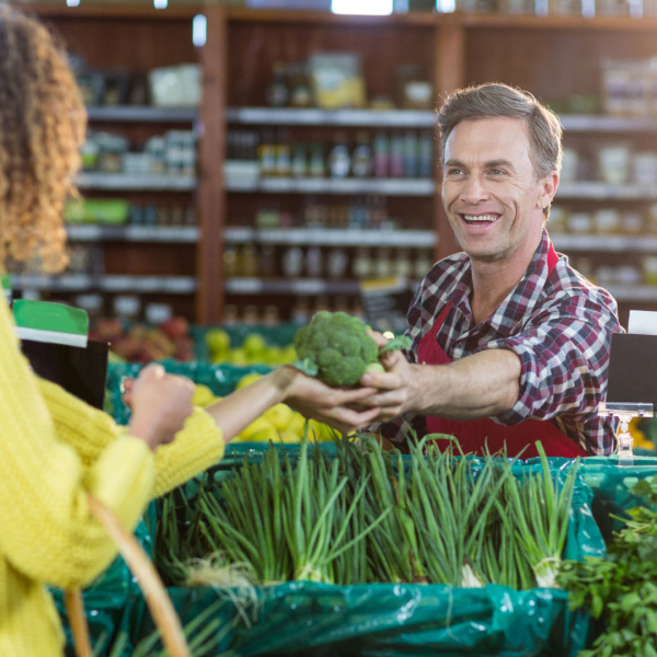 people and market stall with vegetable