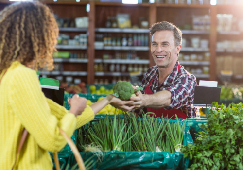 people and market stall with vegetable