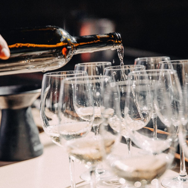 Bottle of wine poured in glasses