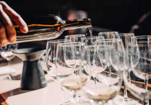 Bottle of wine poured in glasses